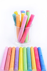 rainbow colored chalk arranged on a white background, chalk isol