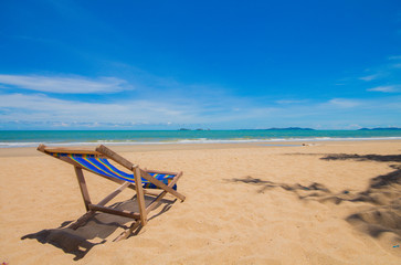 Fototapeta na wymiar Canvas chair on beach and blue sky