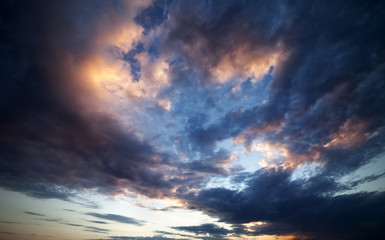 Naklejka na ściany i meble Dark clouds at sunset. Wide angle view.