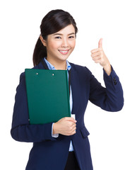 Businesswoman holding clipboard showing thumb up