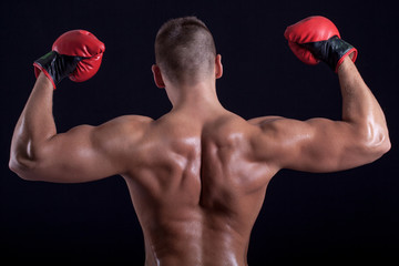 Fototapeta na wymiar Boxer man showing his back with red gloves