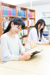 young asian women reading a book in the library