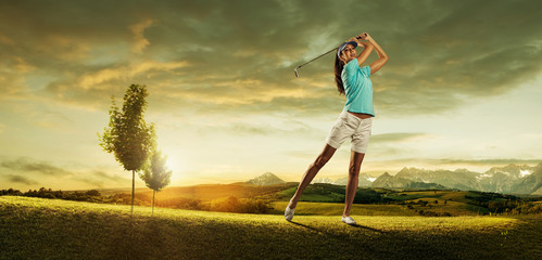 Woman golfer hitting the ball on the  scenery  beautiful