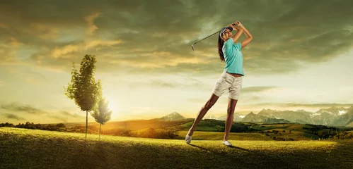 Gordijnen Woman golfer hitting the ball on the  scenery  beautiful © Zsolnai Gergely