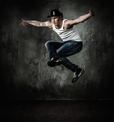Fototapeta na wymiar Man dancer showing break-dancing moves