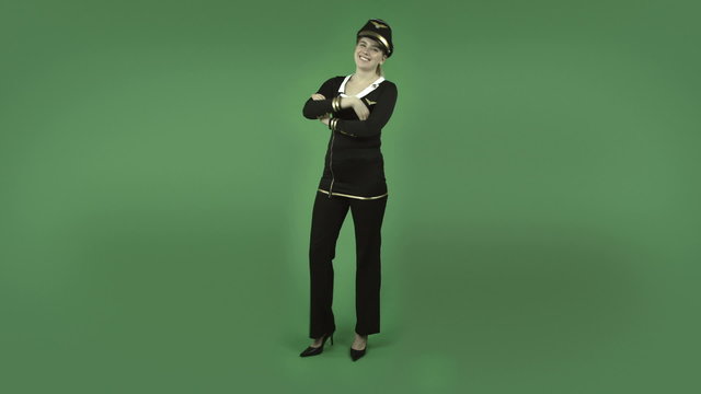 attractive caucasian air hostess isolated on green happy dance