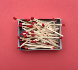 a box of matches on red background