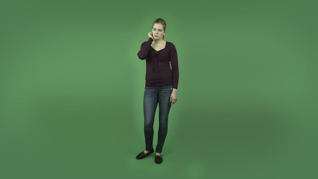attractive casual caucasian girl isolated on green thinking