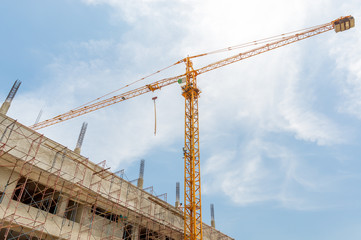 Construction site with cranes on sky background.