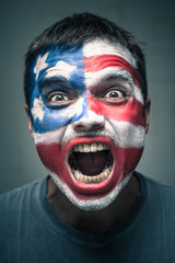 Angry man with USA flag painted on face