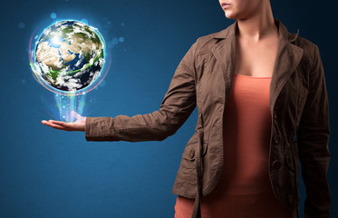 Woman holding glowing earth globe