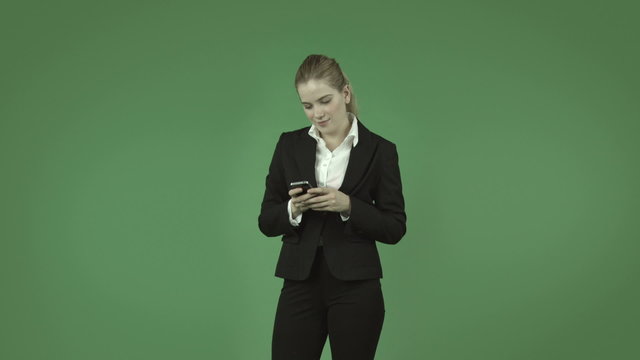 attractive caucasian business girl isolated on green using cell