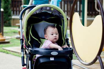 Baby girl resting happily in the park