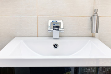 Fototapeta premium White sink and soap dispenser.