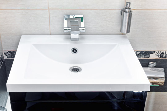 White sink and soap dispenser.