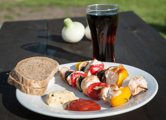 skewers on a plate on wooden table