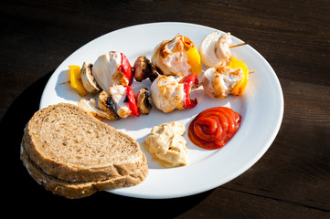 skewers on a plate on wooden table