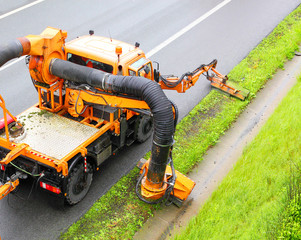 Maintenance on the highway mowing the lawn.