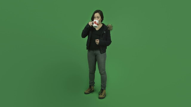 caucasian girl with winter jacket isolated on green screen in