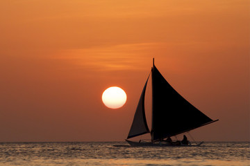 Sunset cruise on traditional island sailboats