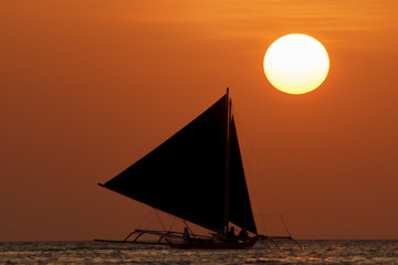 Sunset cruise on traditional island sailboats