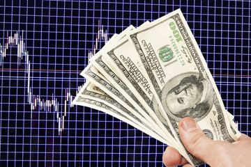 Dollar notes in hand on a blue background with the schedule