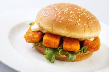 Fishburger and mayonnaise on white plate