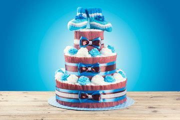 cake made from diapers standing on wooden table