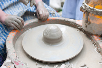 Fototapeta na wymiar Pottery - formation process of the clay dish with traditional me