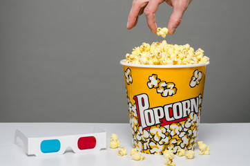 Fototapeta premium Hand reaching for popcorn