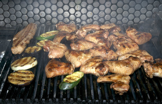 cooking chicken wings on a grill in the restaurant
