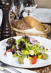 Greek salad on a white background in the restaurant