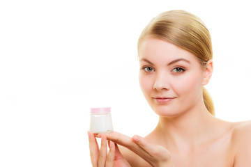 Skin care. Girl applying moisturizing cream.