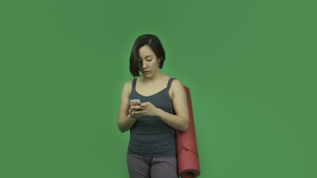 caucasian sporty girl with yoga mat isolated on green screen
