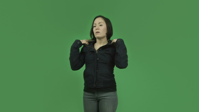 caucasian girl with winter jacket isolated on green screen