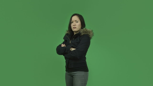 caucasian girl with winter jacket isolated on green screen upset