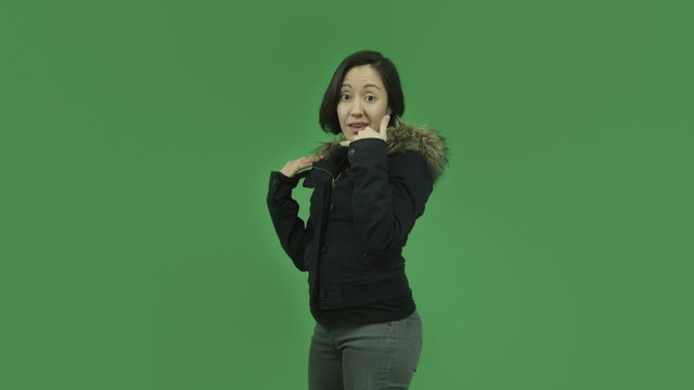 caucasian girl with winter jacket isolated on green screen with
