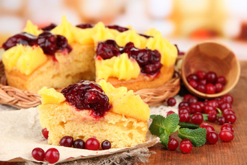 Tasty fruity homemade pie with berries, on brown wooden table