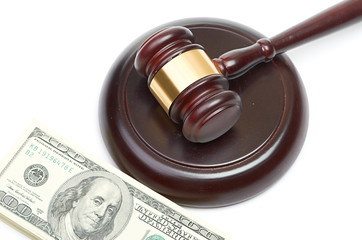 Law gavel on a stack of American money.