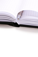 Pen on opened book, close up