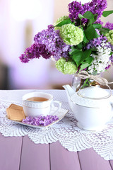Composition with teapot,  mug and beautiful spring flowers in
