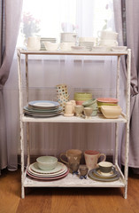 Different tableware on shelf in the interior