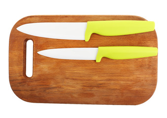 Kitchen knives and cutting board isolated on white
