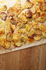 Homemade potato chips on wooden table
