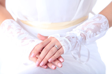 Obraz premium Wedding gloves on hands of bride, close-up