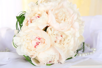 Beautiful wedding bouquet on table on light background