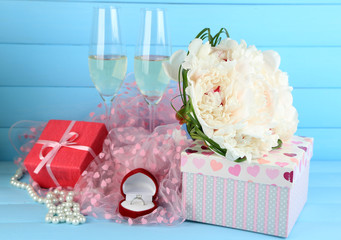 Fototapeta na wymiar Beautiful wedding bouquet, gift box and wine glasses