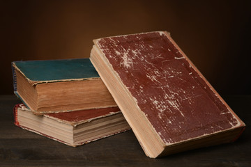 Old books on table on brown background