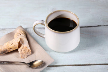 Cup with hot coffee on color  wooden background