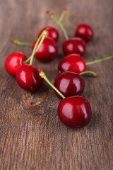 Ripe sweet cherries on wooden table